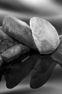 Black and white photograph of boulders above water by iCanvas artist Jeff Friesen