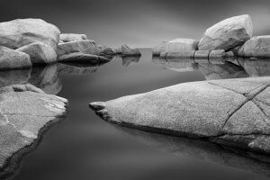 Black and white nature art of boulders above water in Nova Scotia by iCanvas artist Jeff Friesen