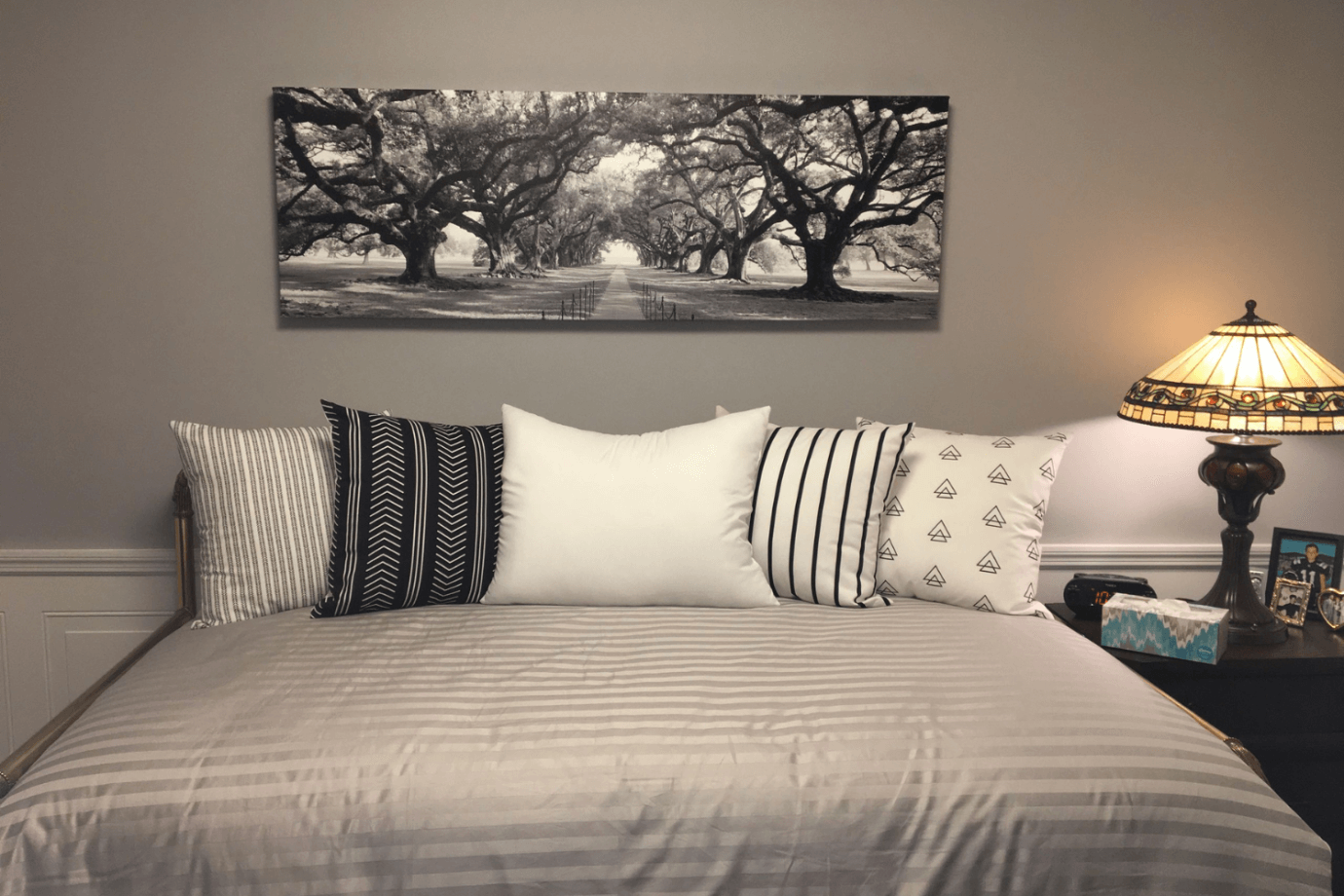 black and white forest photograph above bed