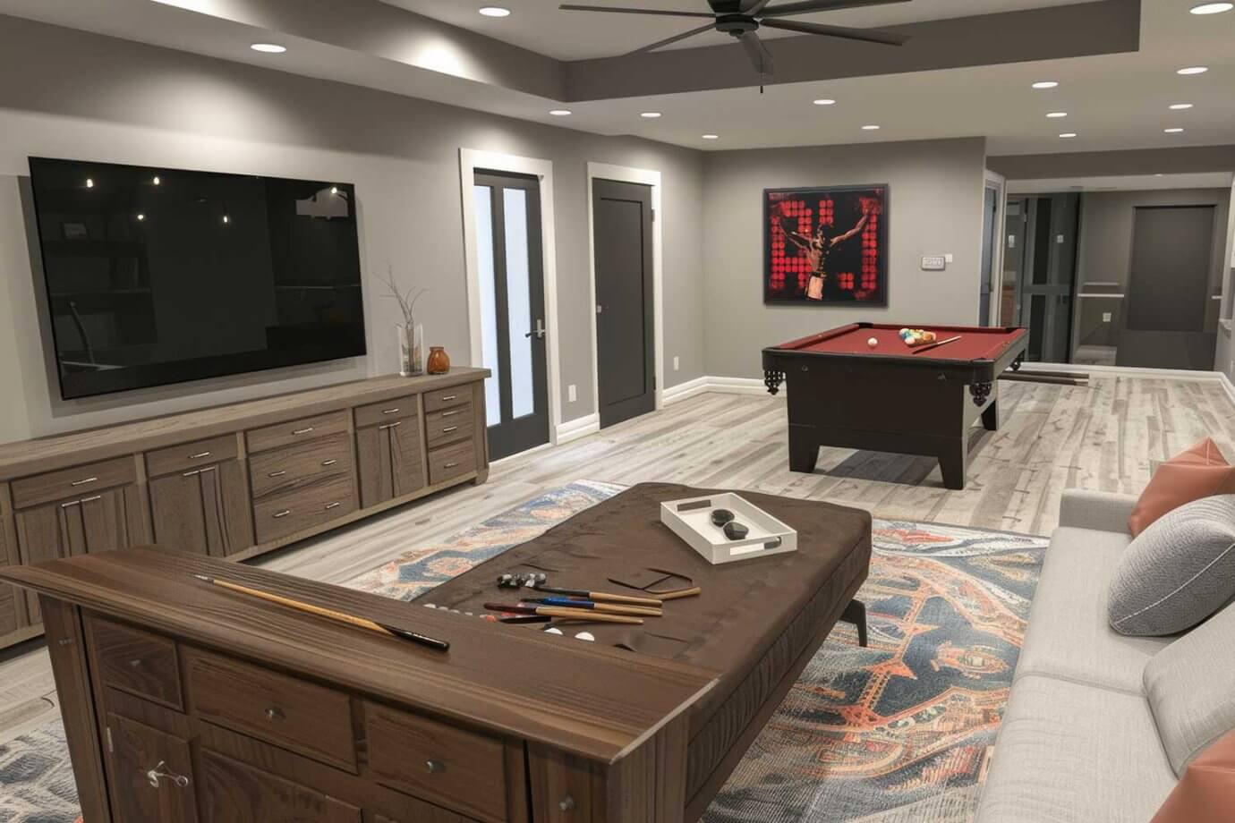 sports art hanging in basement with pool table