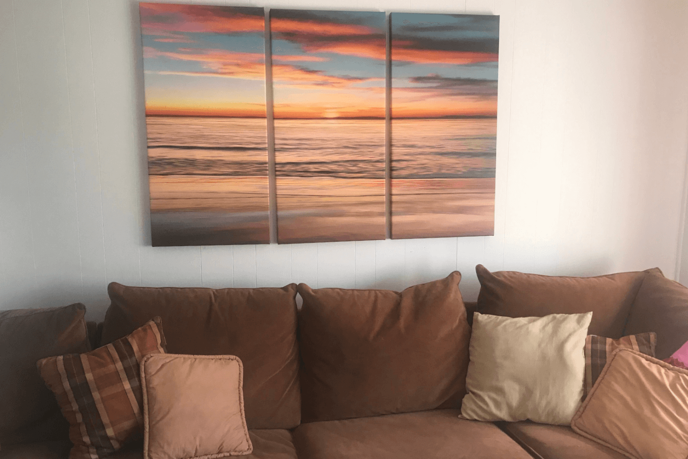 ocean sunset photo above couch