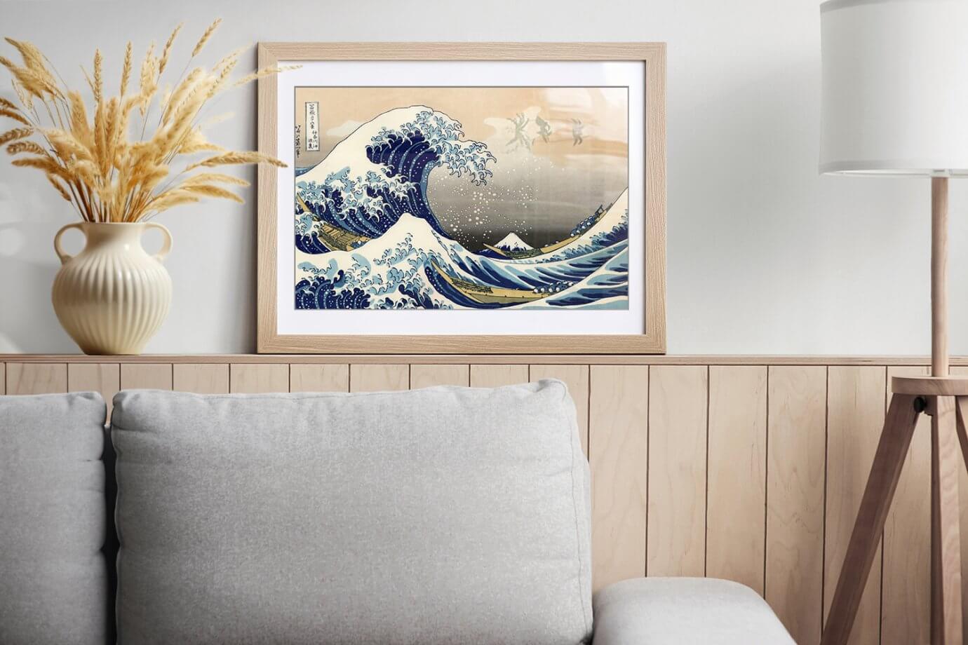 the great wave painting framed above couch