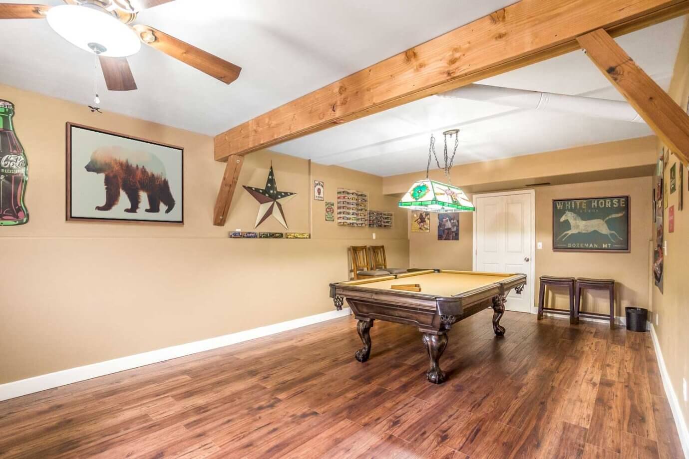 wildlife artwork hanging in room with pool table