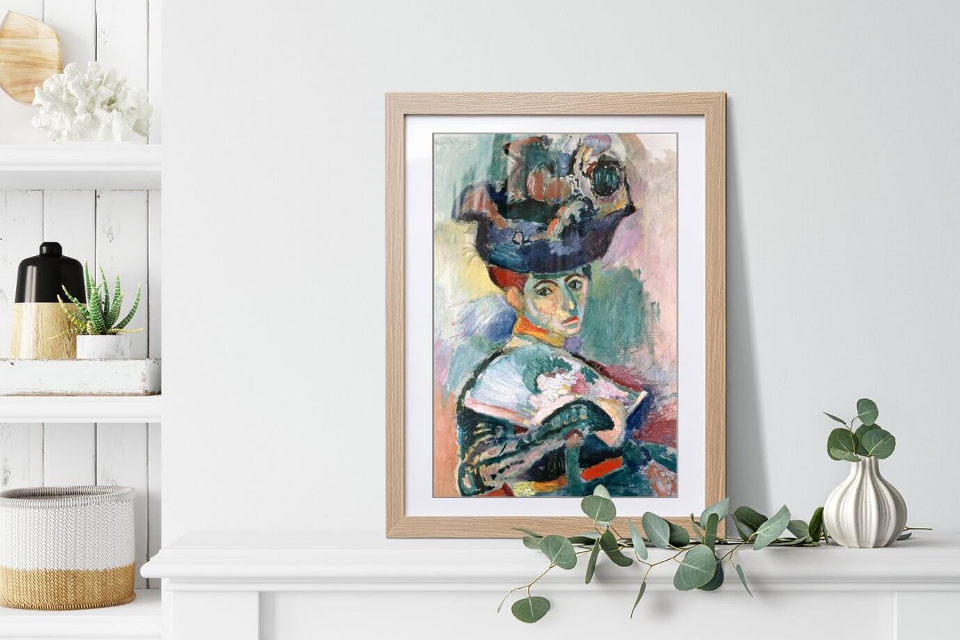 woman in a hat painting leaning on a ledge