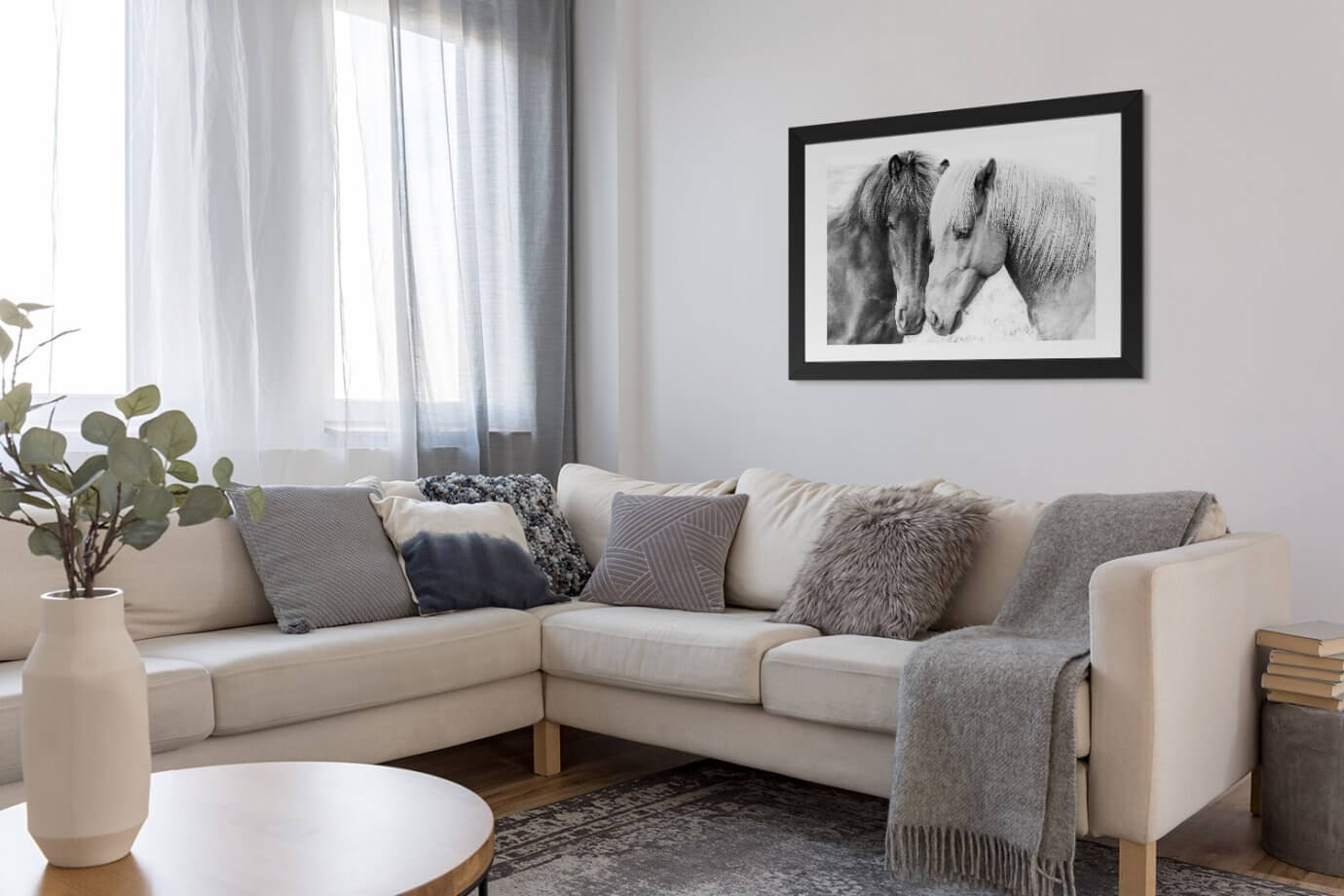 black and white horse art above couch