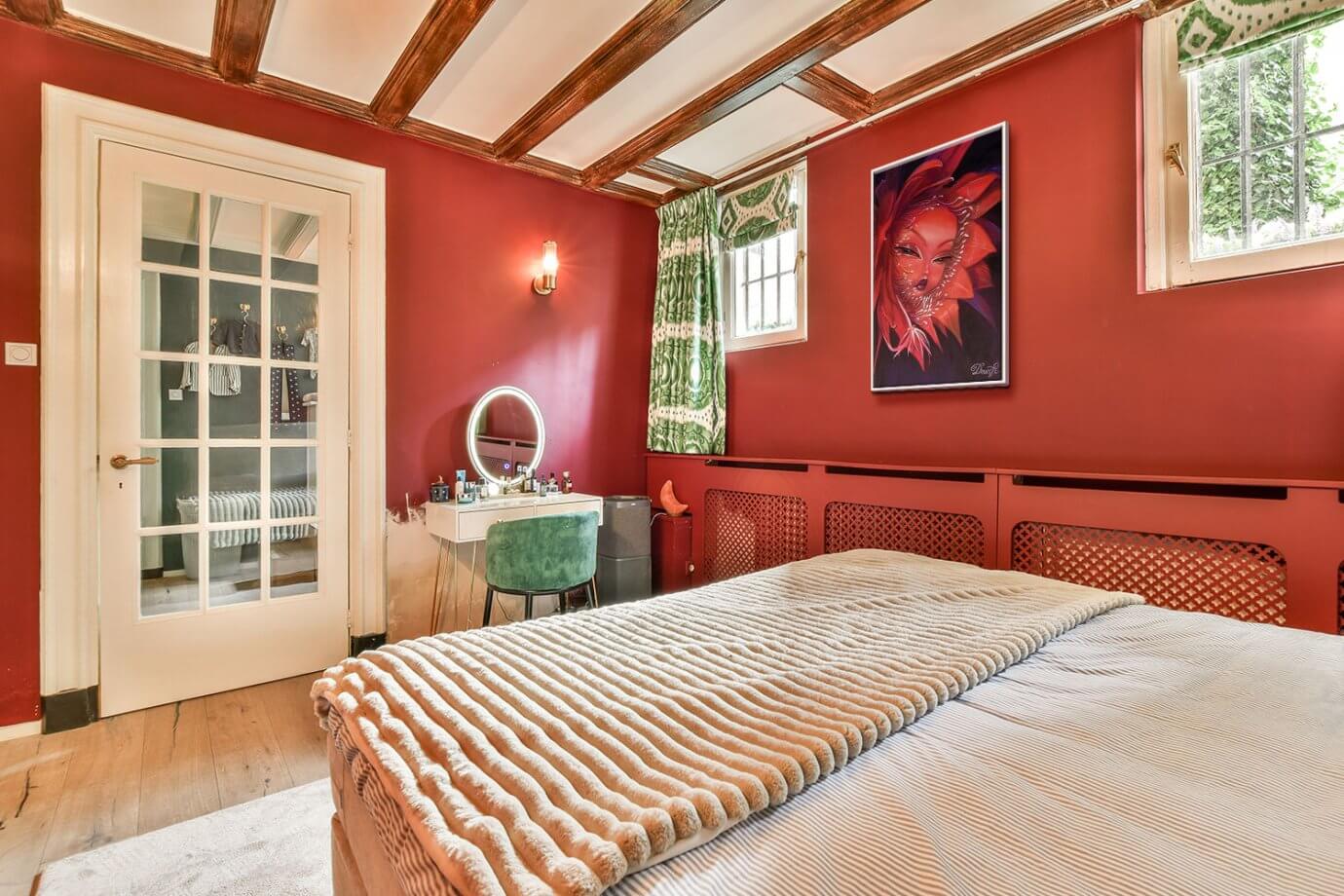 color drenching red artwork in red bedroom